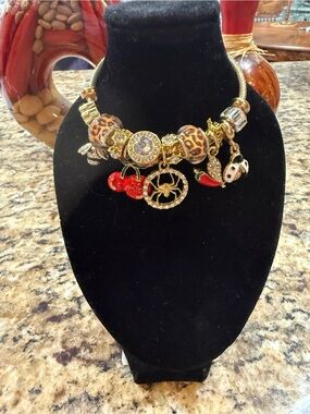 Gold Charm Statement bracelet with Leopard Beads and Red Accents